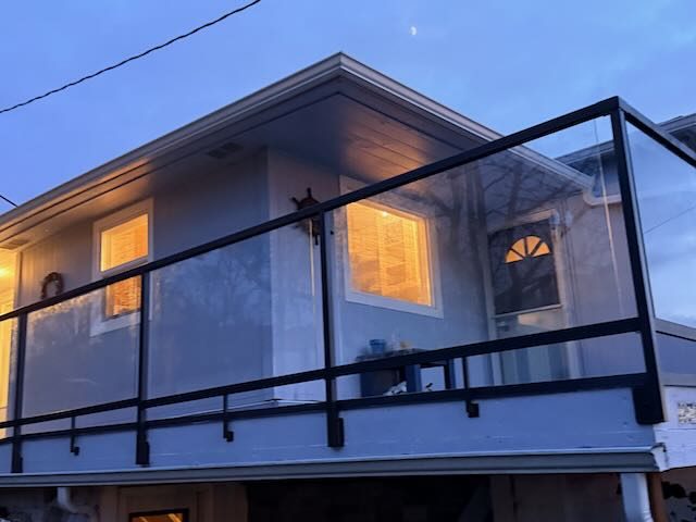 Glass panel deck railing with warm evening glow